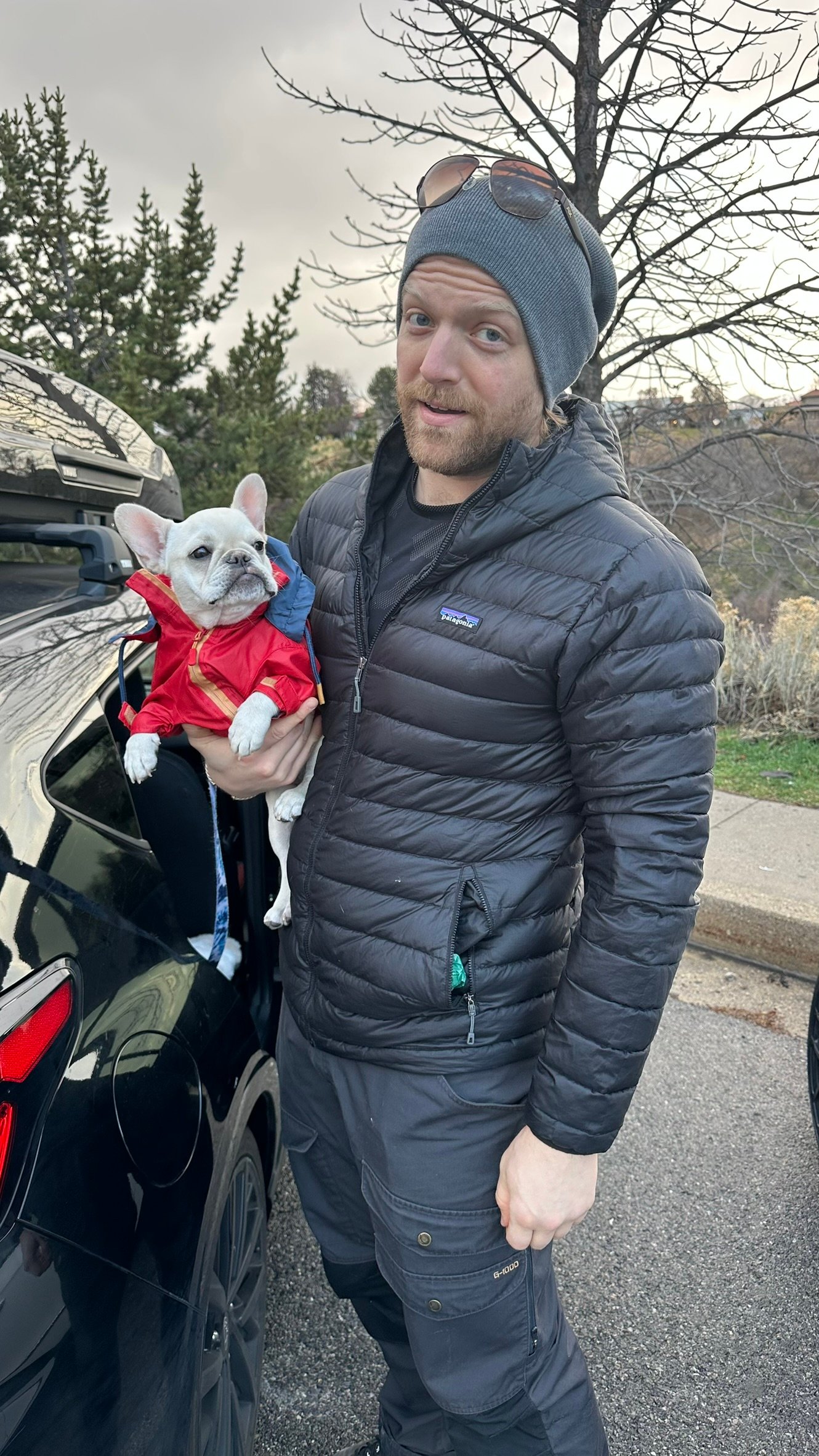 Man holding a French Bulldog